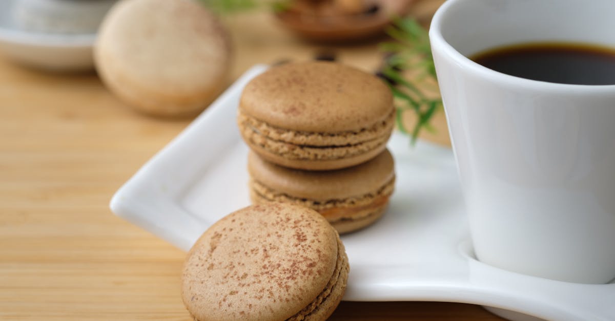 A close-up of French macarons served with a cup of coffee, perfect for a gourmet dessert setting.
