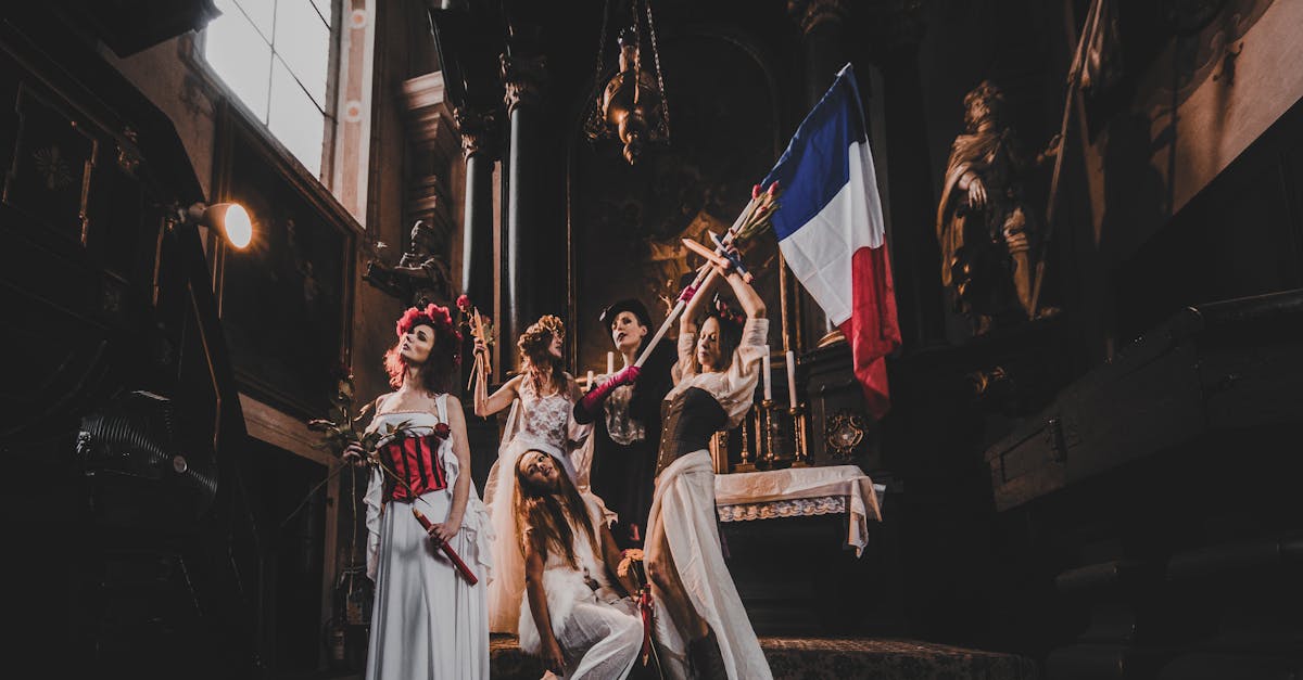 Performers in costume with French flag inside historic church, dramatic lighting.