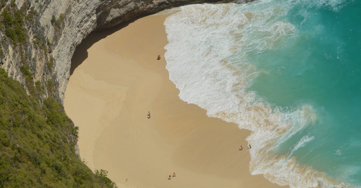 A breathtaking aerial view of a secluded beach in Bali, Indonesia with turquoise waters.