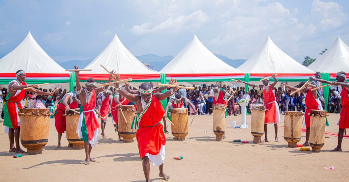 Colorful cultural drumming performance outdoors with traditional costumes and lively audience.