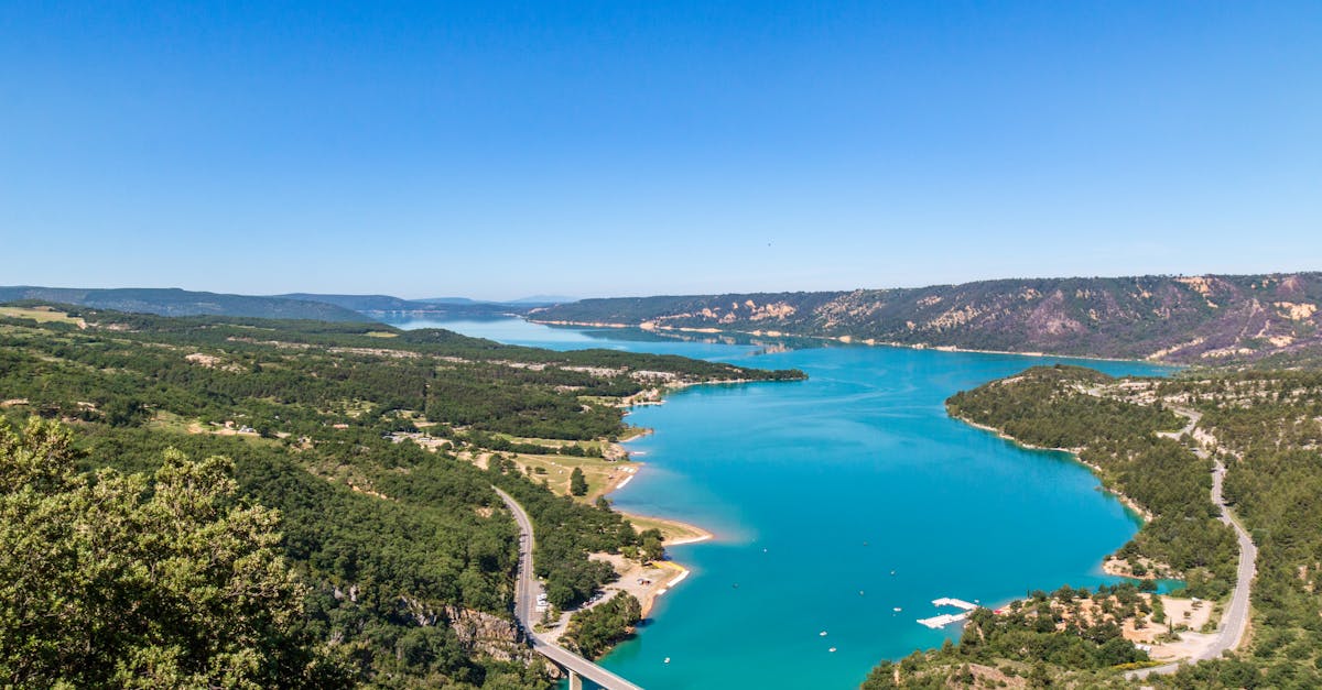 A breathtaking aerial shot of striking blue lake amidst lush greenery in Moustiers-Sainte-Marie, France.