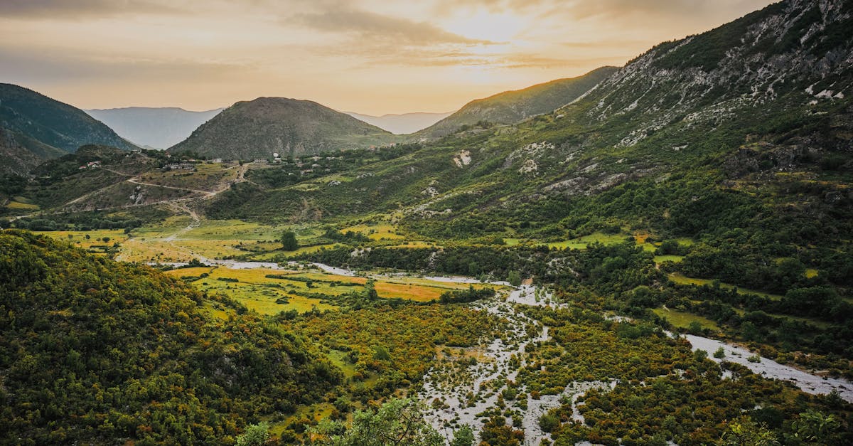 A breathtaking aerial view of Zhulat's lush mountains during sunset in Gjirokastër County, Albania.