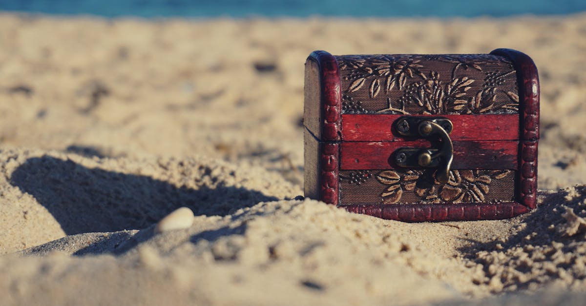 A decorative treasure chest sits on a sunny beach, invoking mystery and adventure.