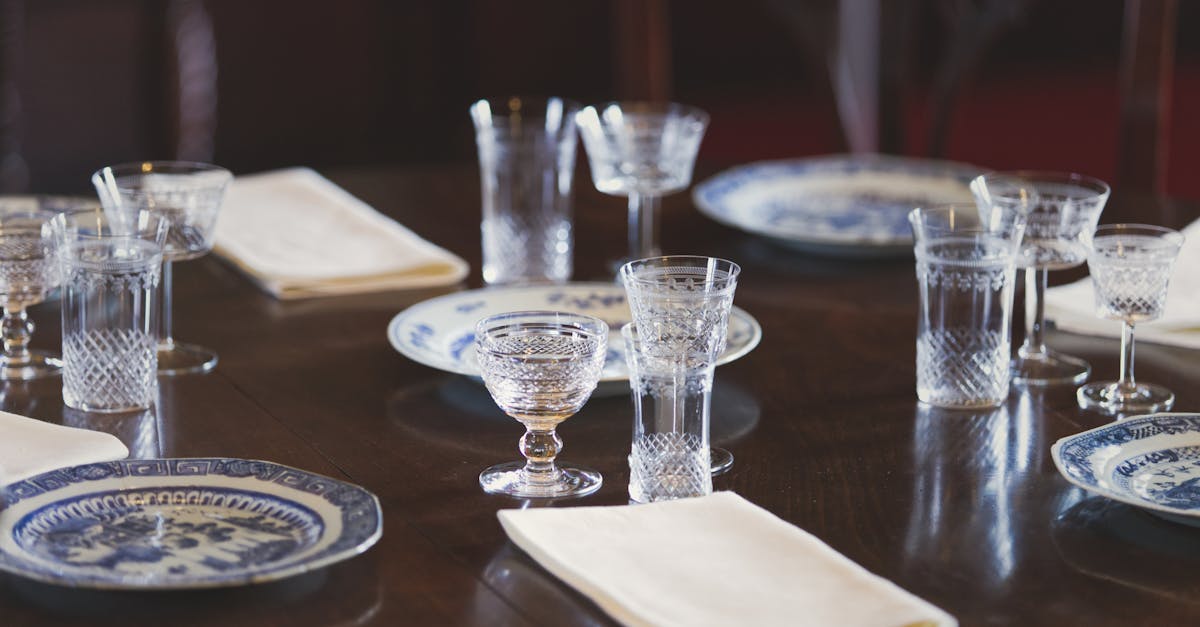 A sophisticated dining table setting with crystal glasses and blue porcelain plates, adding elegance to any occasion.