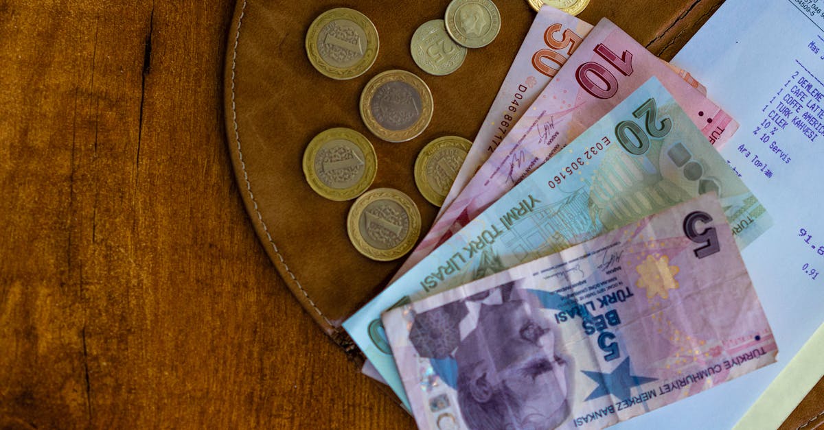 Close-up of Turkish lira coins and banknotes on a wooden surface alongside a receipt.