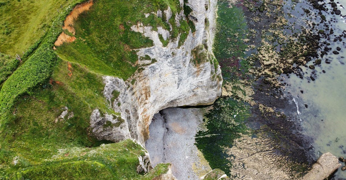 A breathtaking aerial view of Étretat's cliffs and rocky seashore in Normandy, France.