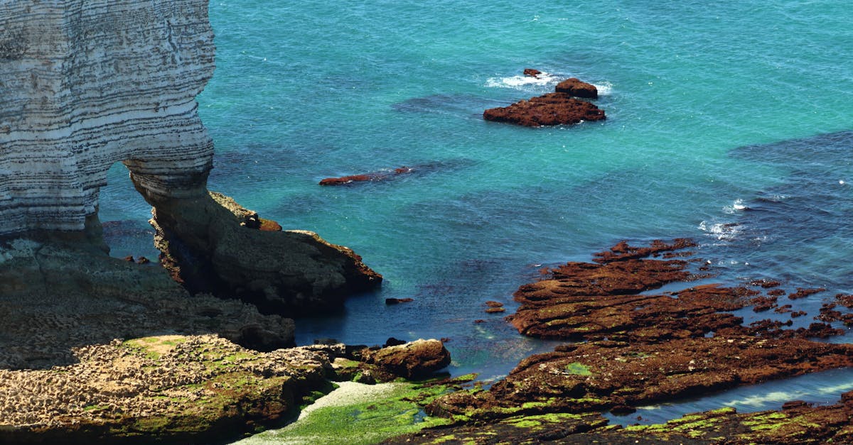 A serene seascape with rocky cliffs and vivid turquoise waters, showcasing natural beauty.