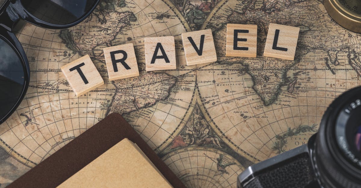 Vintage map with travel essentials like camera and sunglasses arranged in a flat lay, perfect for adventure themes.