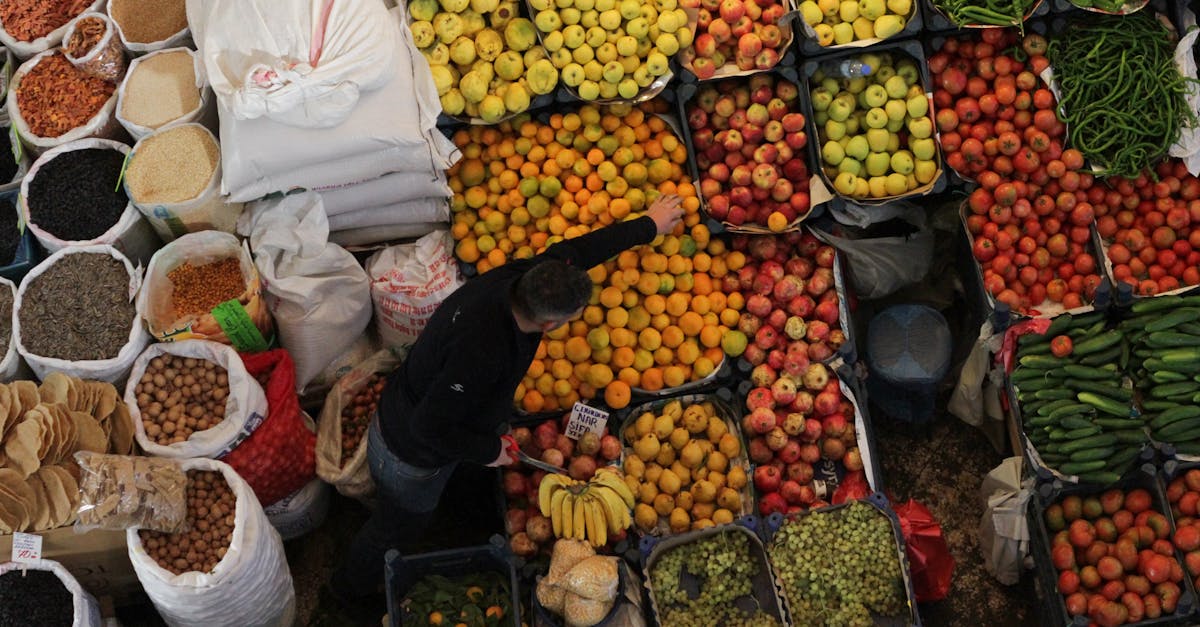 Aerial view of a bustling fruit and vegetable market stall showcasing a variety of fresh produce.