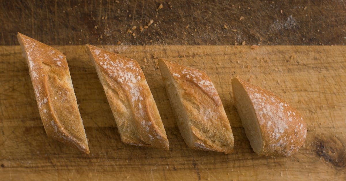 Close-up of freshly sliced baguette on a rustic wooden surface, highlighting texture.