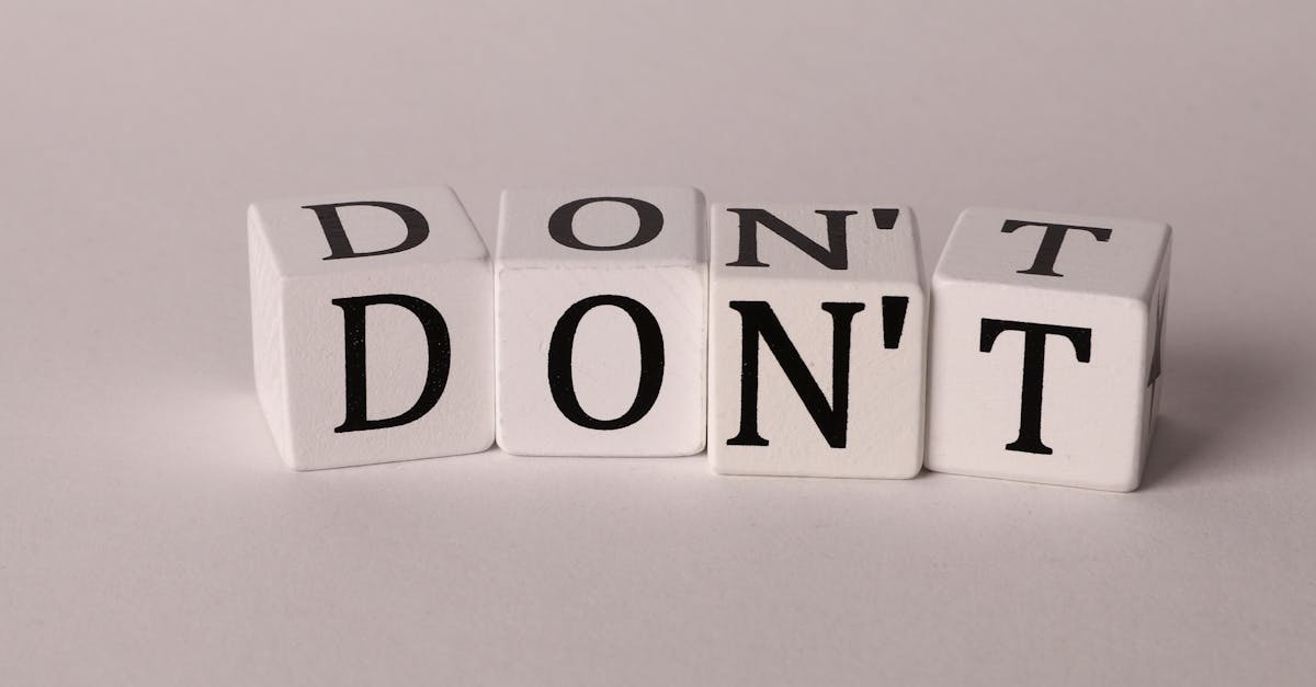 Text cubes spelling 'DON'T' on a clean white background, ideal for concepts of caution or prohibition.