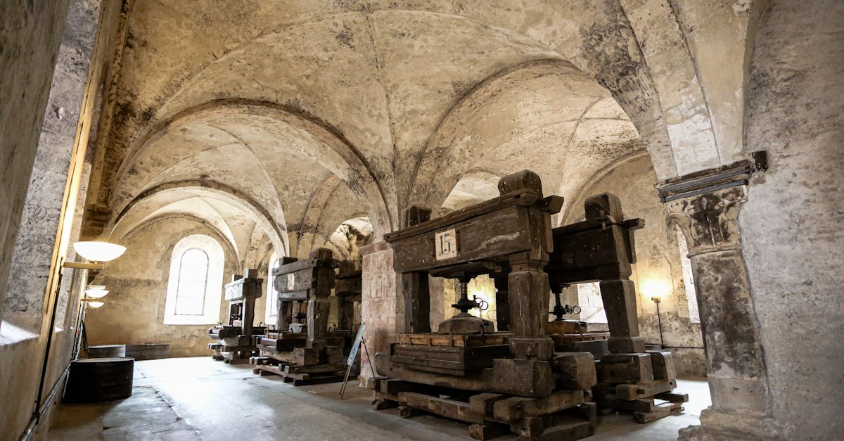 Ancient wine presses inside the historic Eberbach Abbey in Germany, showcasing medieval architecture.