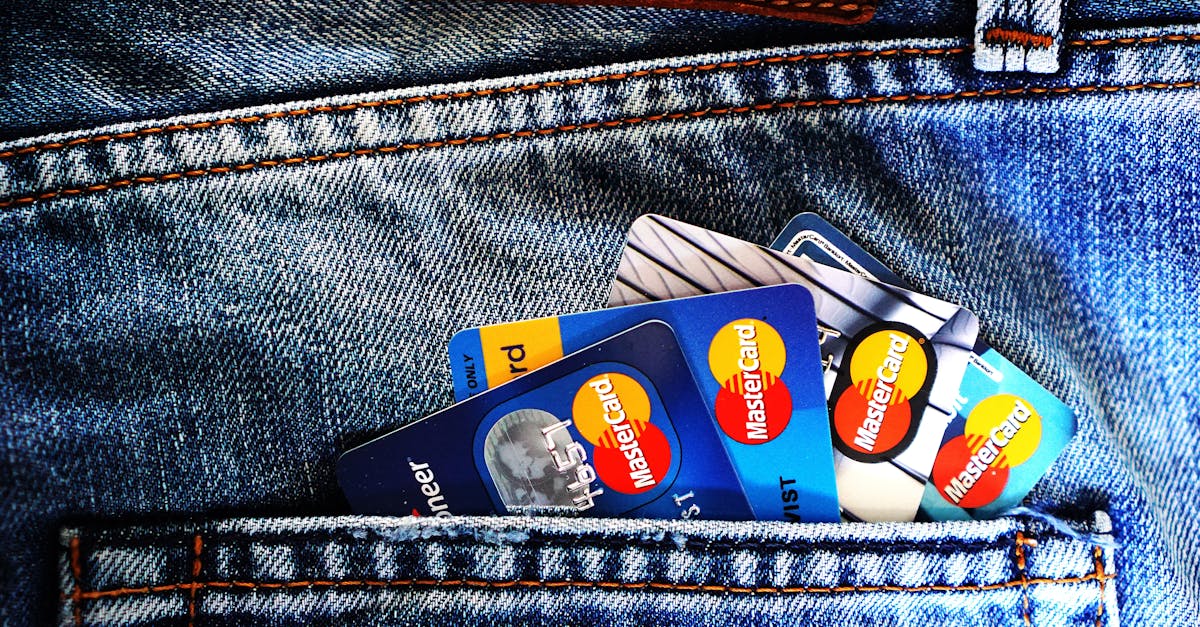 Close-up of a denim pocket with multiple credit cards, illustrating finance and fashion.