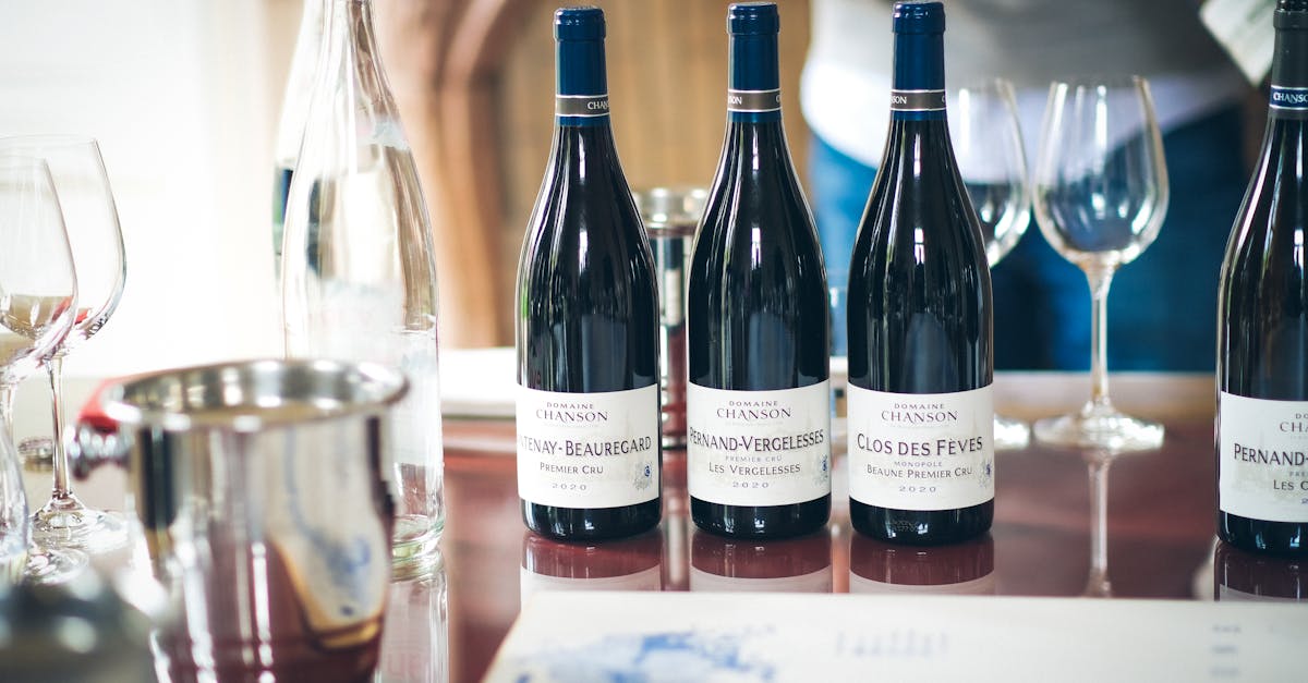 Elegant wine tasting setup in Beaune, featuring French wine bottles and glasses on a table.