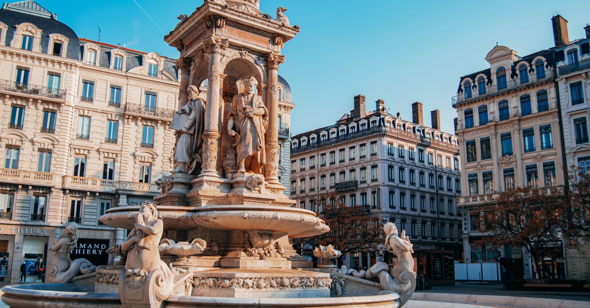 Elegant fountain at Place des Jacobins, Lyon, showcasing historic architecture in a vibrant urban setting.