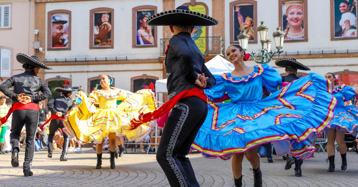 Colorful traditional Mexican dancers performing in a lively town square.