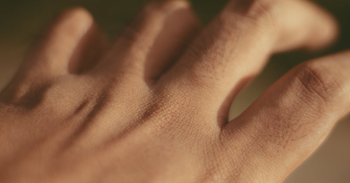 Macro shot of a human hand focusing on skin texture and pores in natural light.