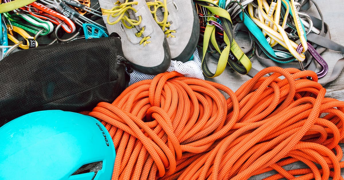 Close-up of mountain climbing gear including ropes, helmet, and harnesses for safety.