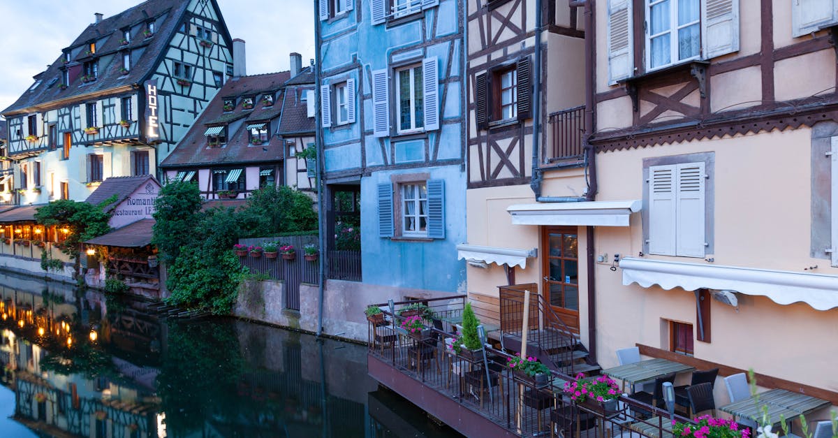 Picturesque view of traditional half-timbered houses along the canal in Colmar, France.