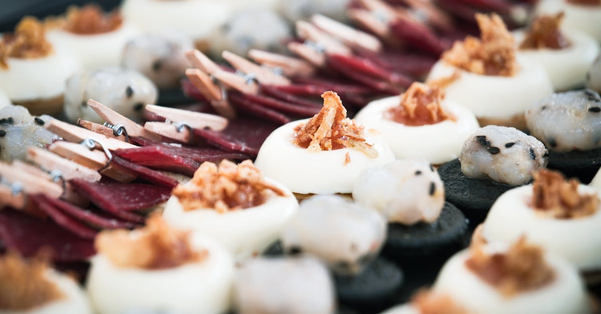 Close-up of a gourmet appetizer platter featuring various pastries and toppings, perfect for culinary presentations.