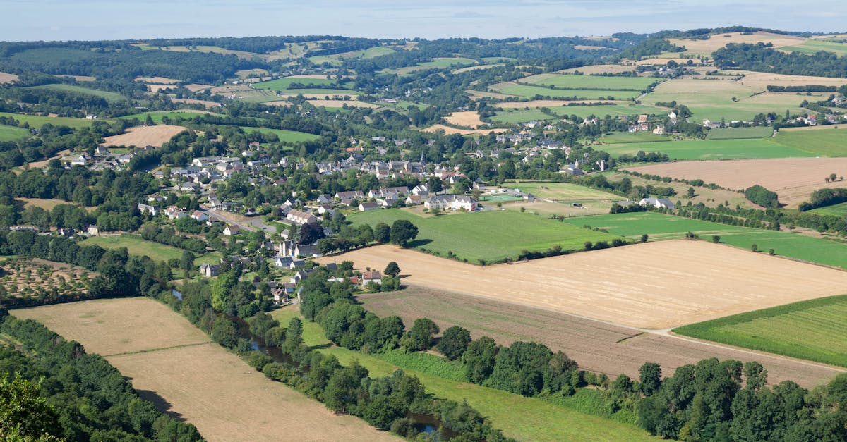 Stunning aerial view of Clécy village and lush countryside in Normandy, France.