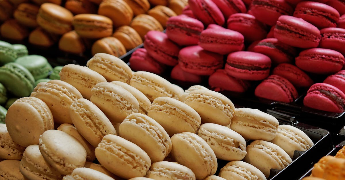 Delicious variety of colorful macarons displayed on trays, perfect for dessert lovers.