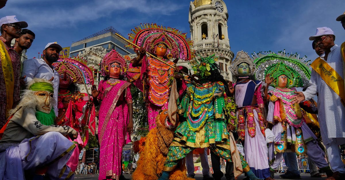 Vibrant festival parade with traditional costumes and performers in central Kolkata, India.