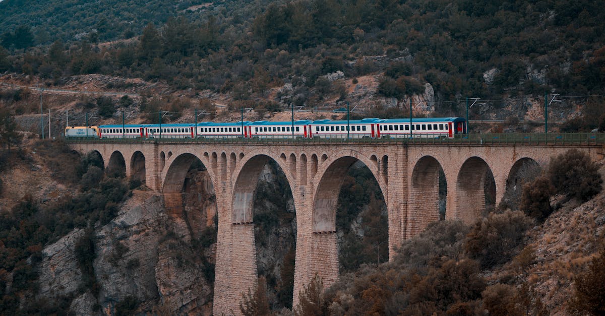 Beautiful view of a train crossing a historic stone viaduct in the Turkish valley.
