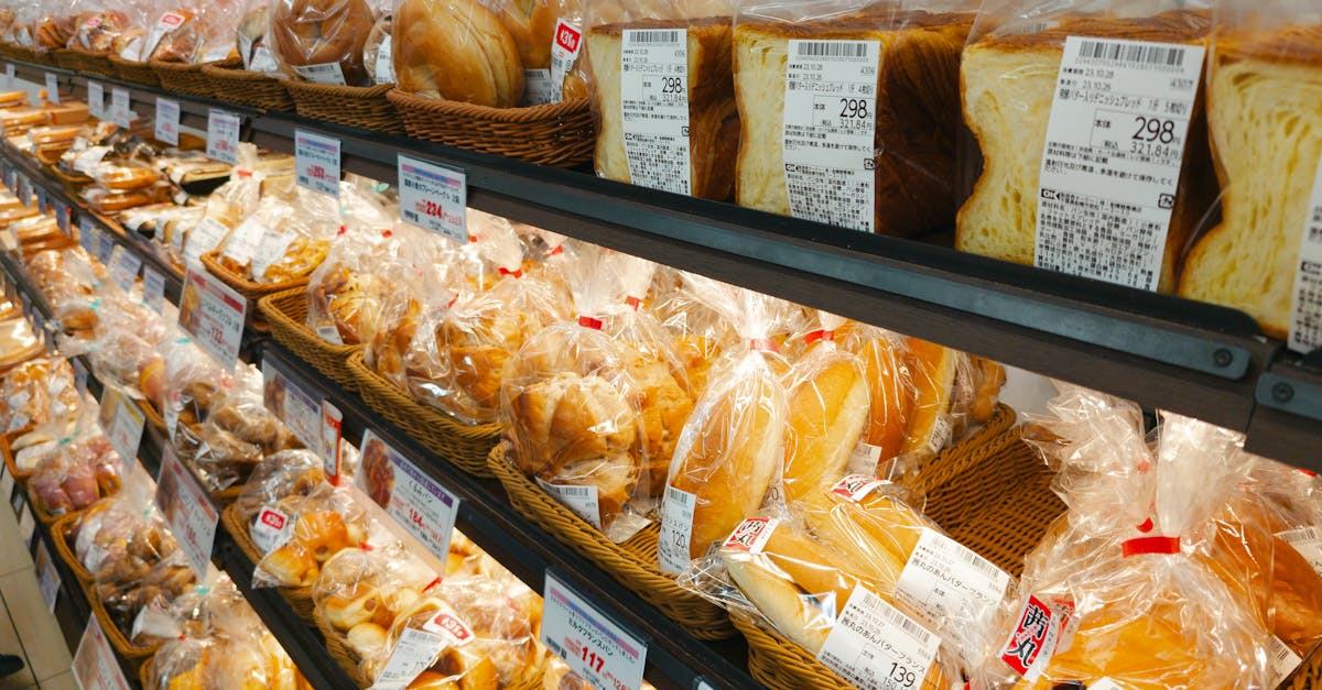 A diverse selection of prepackaged bread in a grocery store aisle, perfect for food-related projects.