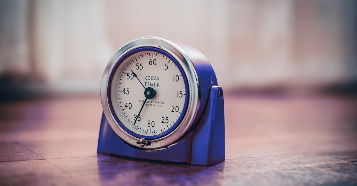 Close-up of a vintage Kodak timer on a wooden surface, highlighting retro design and time measurement.