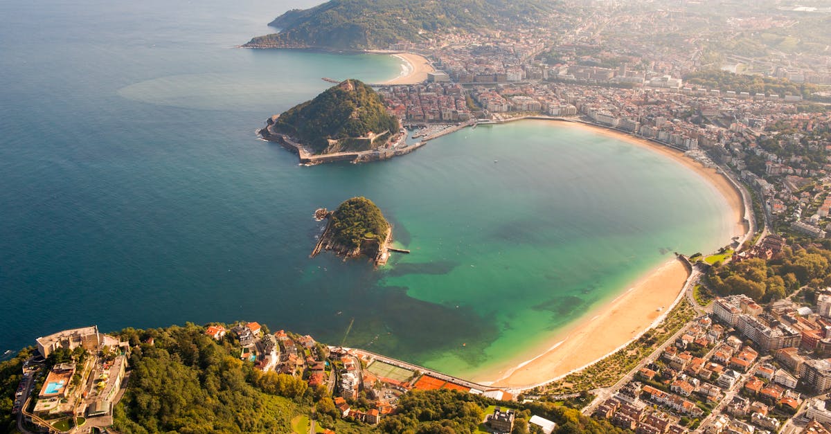 Stunning aerial shot of San Sebastián's La Concha Bay in summer sunlight.
