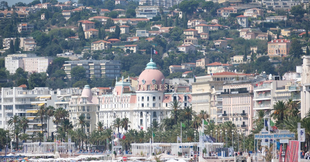 View of the famed beaches and luxurious hotel in Nice, France, during a vibrant summer day.
