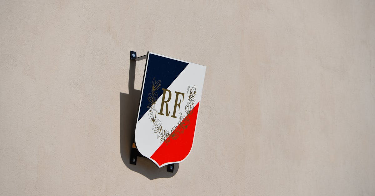 French Republic emblem mounted on a beige building wall, symbolizing national pride.