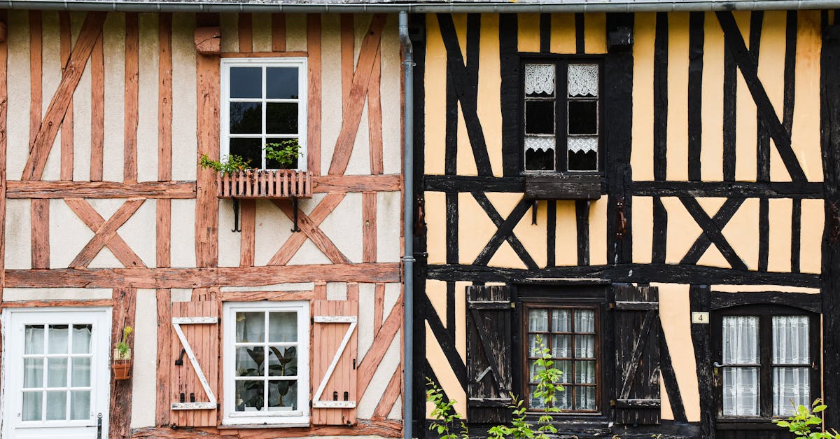 Historic half-timbered houses with wooden shutters in Normandy, France.