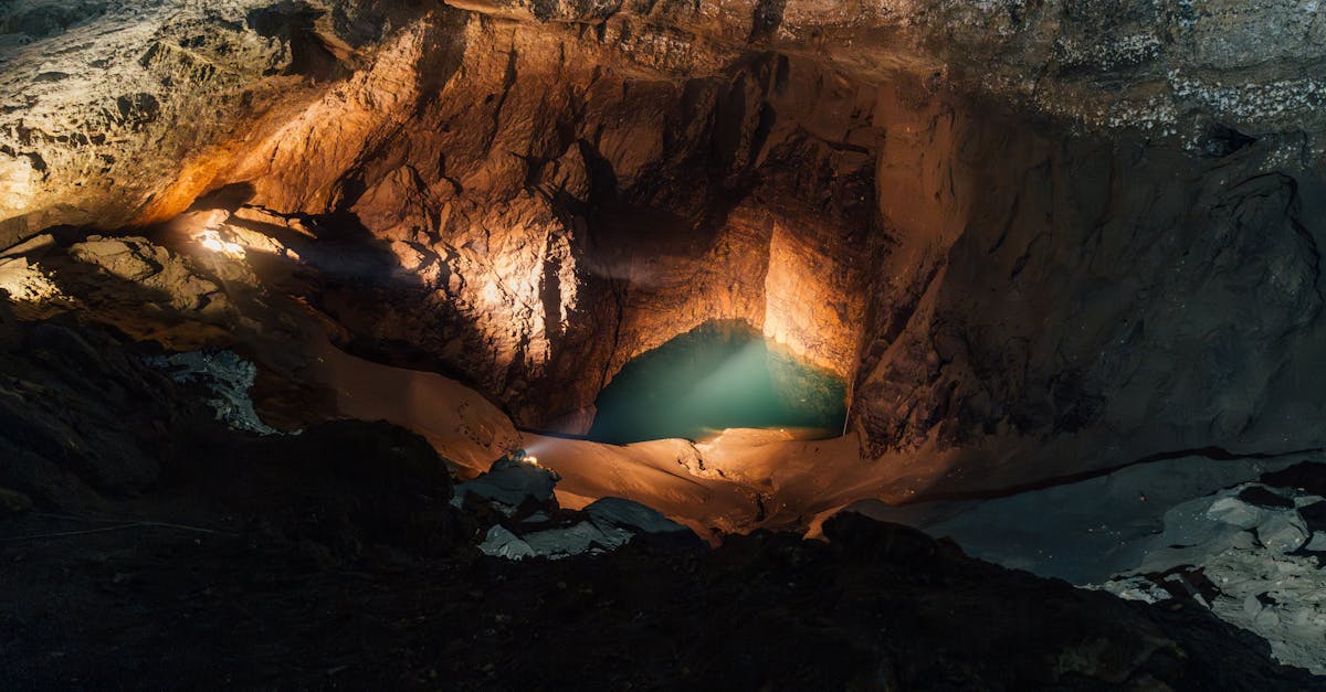 Discover the breathtaking beauty of an illuminated underground cave with a serene water pool in Новый Афон.