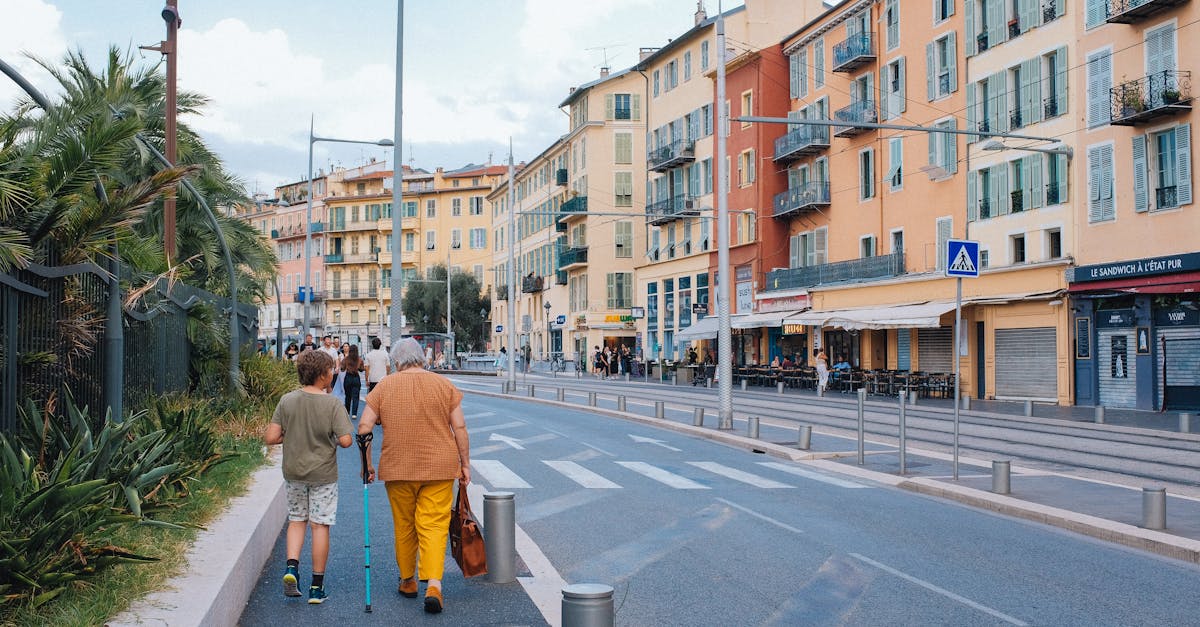 Sunny day on a colorful European street with pedestrians and classic buildings.