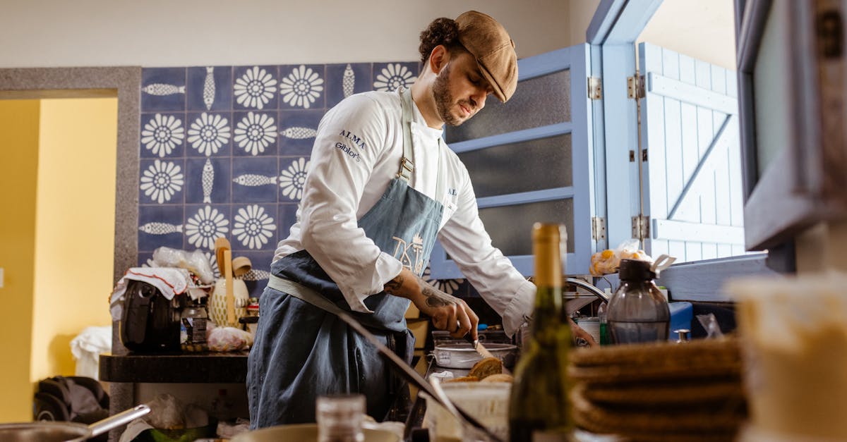 A chef in a rustic kitchen cooks a gourmet meal with an open door filling the room with natural light.