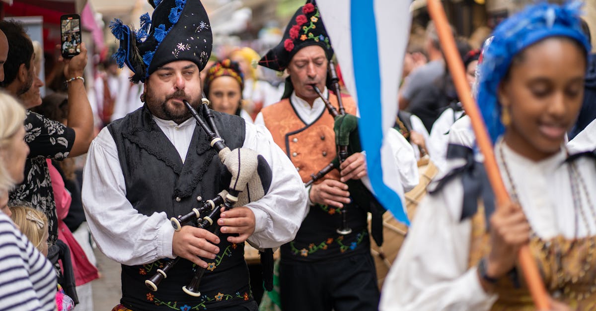 Colorful street musicians playing bagpipes during a festival in Guérande, France.