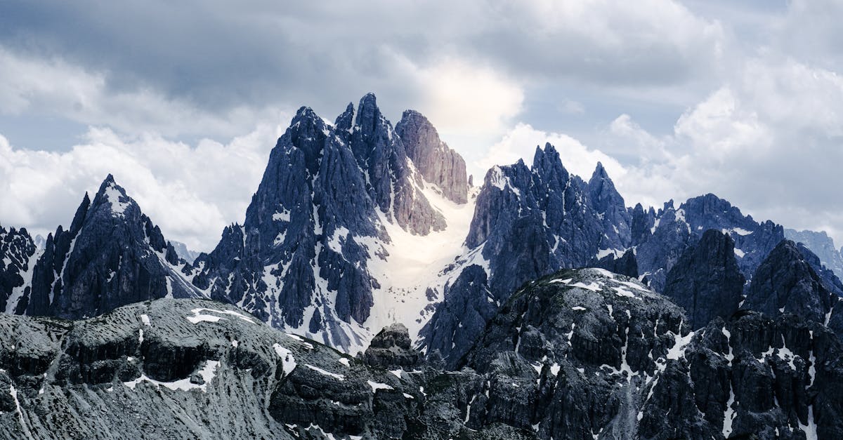 Snow-covered Dolomite Alps with striking light rays in Campitello di Fassa, Italy.
