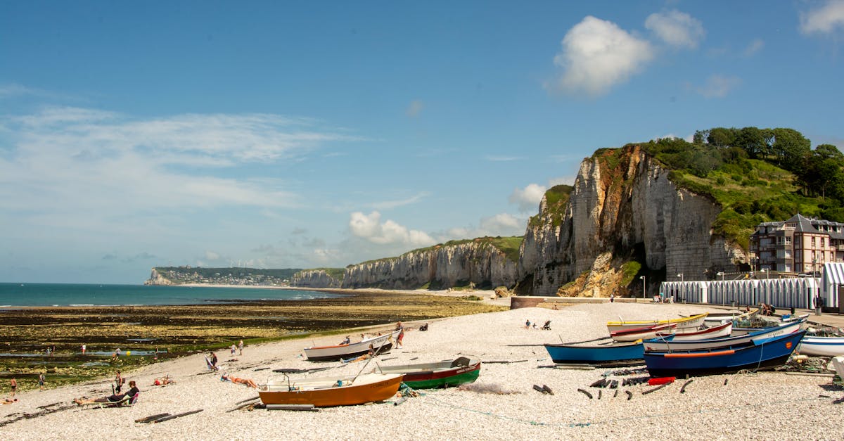 Scenic view of Yport beach with fishing boats and cliffs in Normandy, France.