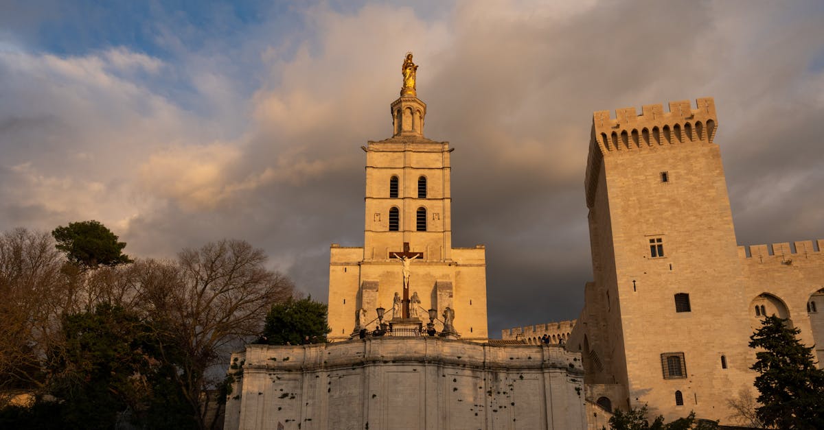 Capture of Avignon Cathedral in the warm glow of sunset, showcasing its historic architecture.