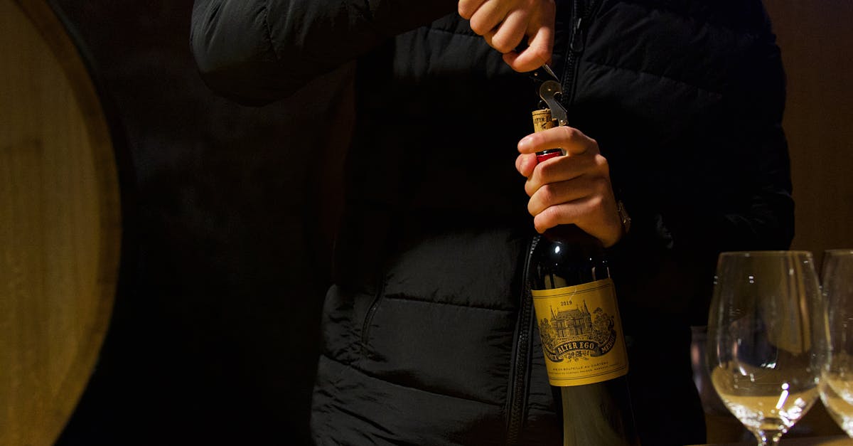 Person uncorking wine bottle in Margaux, Bordeaux. Elegant wine tasting in a French cellar.
