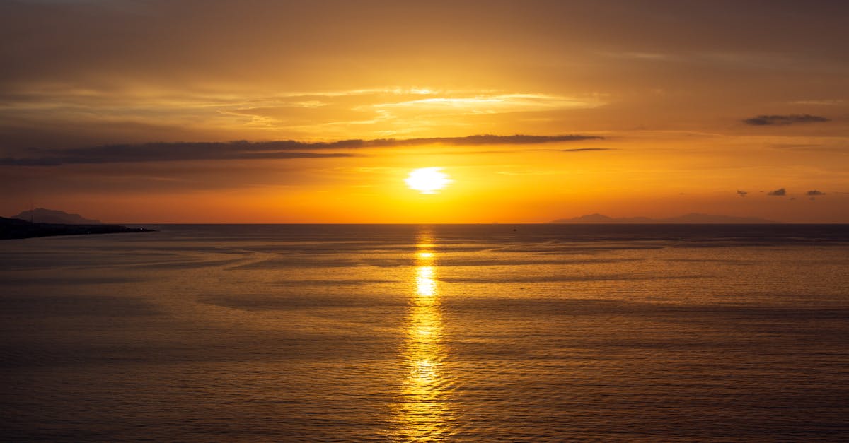 Breathtaking sunset casting golden reflections on the serene ocean waters.