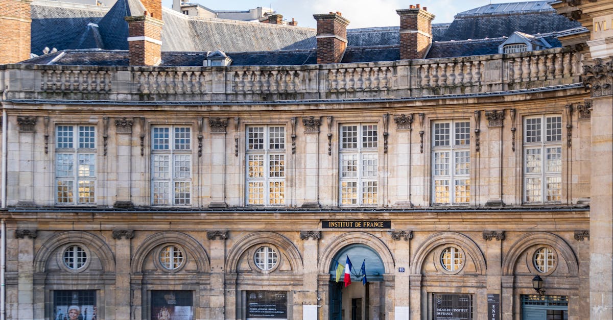Capture of the historic Institut de France showcasing Haussmann architecture in Paris on a clear day.