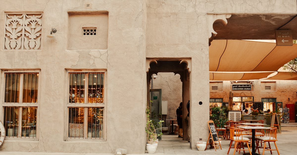 Explore a traditional courtyard in Dubai with rustic architecture and inviting outdoor seating.