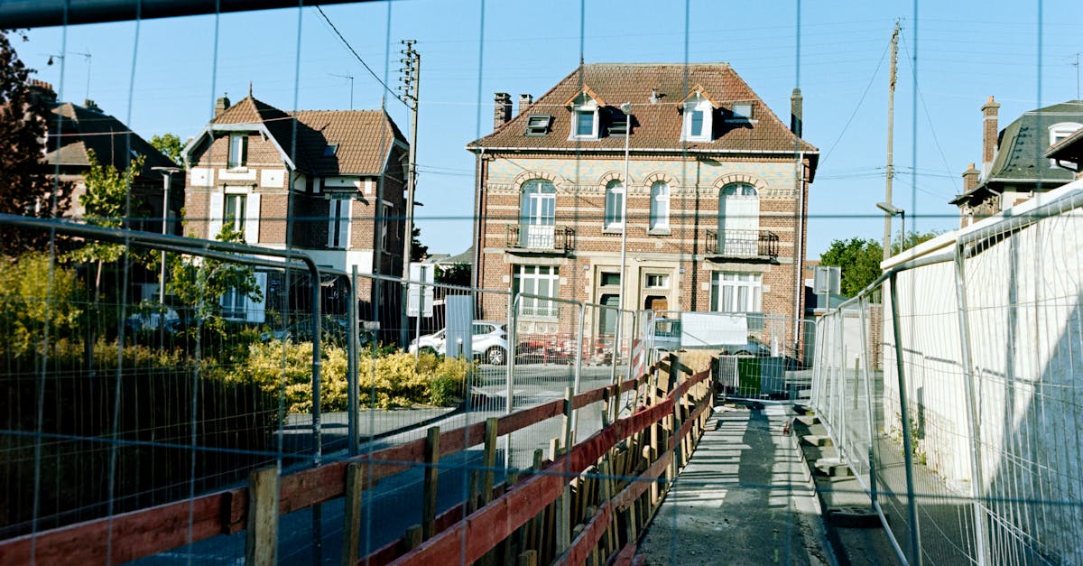 View of traditional French buildings in Compiègne with construction fencing in the foreground.