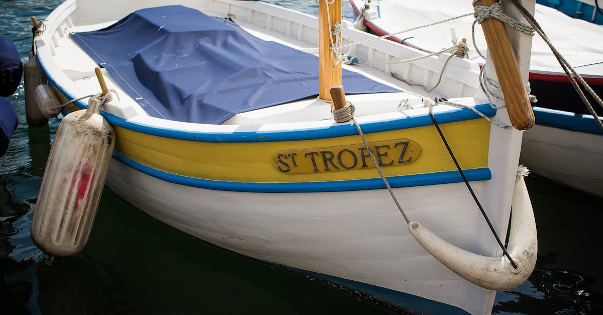 Traditional boat with vibrant colors docked in Saint-Tropez harbor, capturing nautical charm.