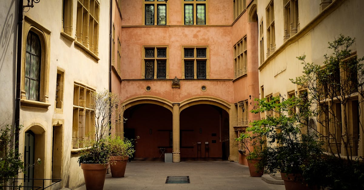 Charming antique courtyard with arches in Lyon, France, showcasing classic architecture.