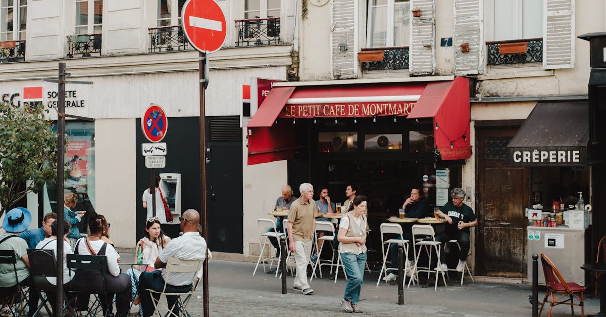 Charming street scene at Le Petit Café de Montmartre with vibrant outdoor dining.
