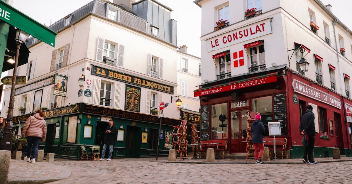 Charming street view of iconic Montmartre cafes in Paris, France.